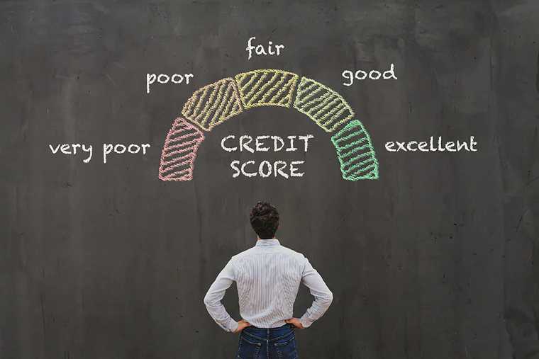 A man facing a black borad with credit score text on